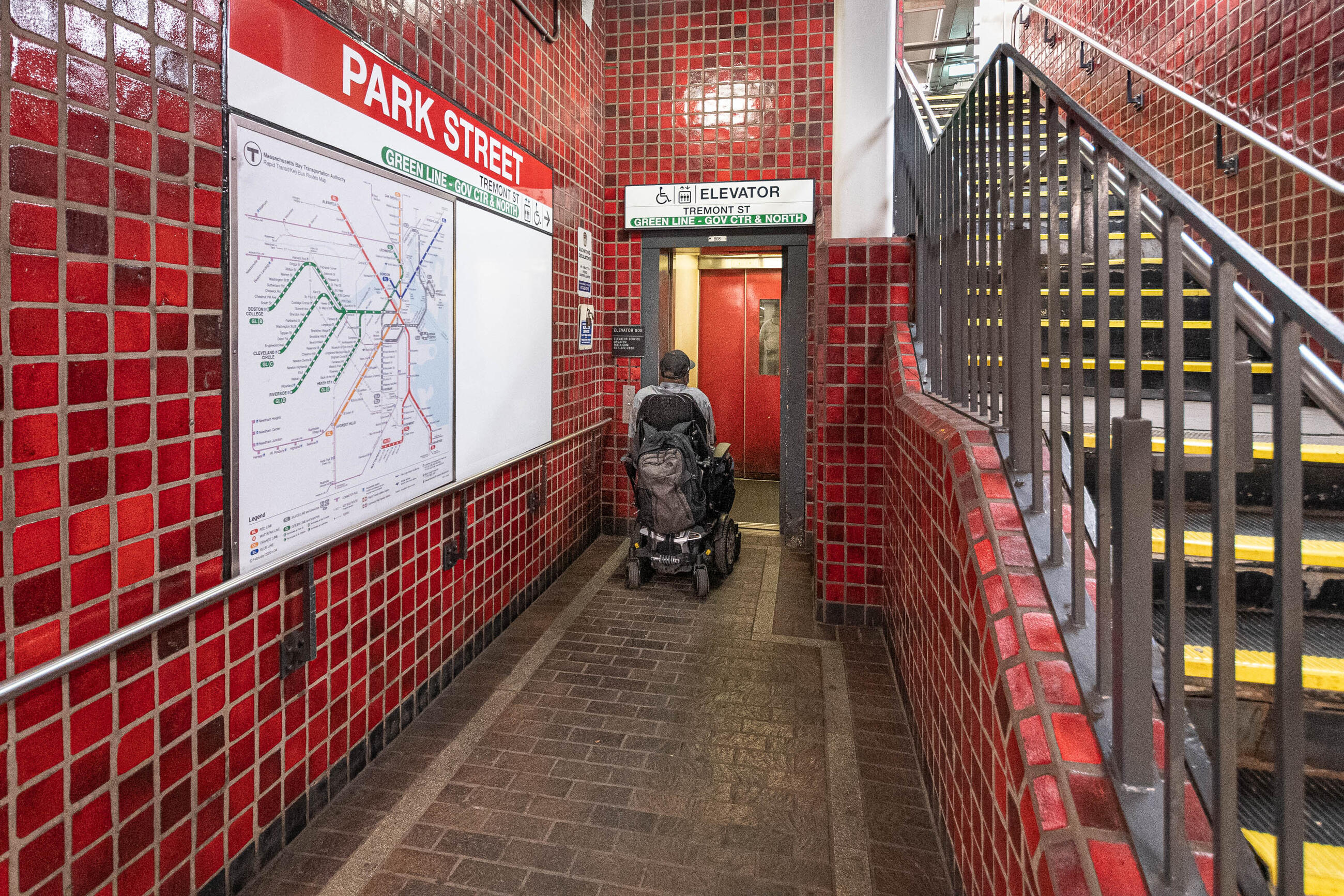 a rider on a wheeled mobility device exits an accessible elevator at Park Street