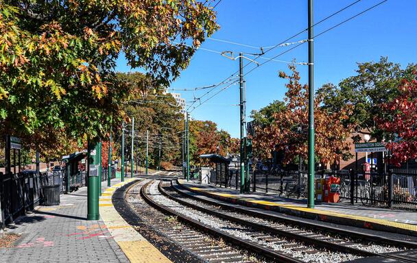 Green Line tracks at Washington Square station surrounded by foliage